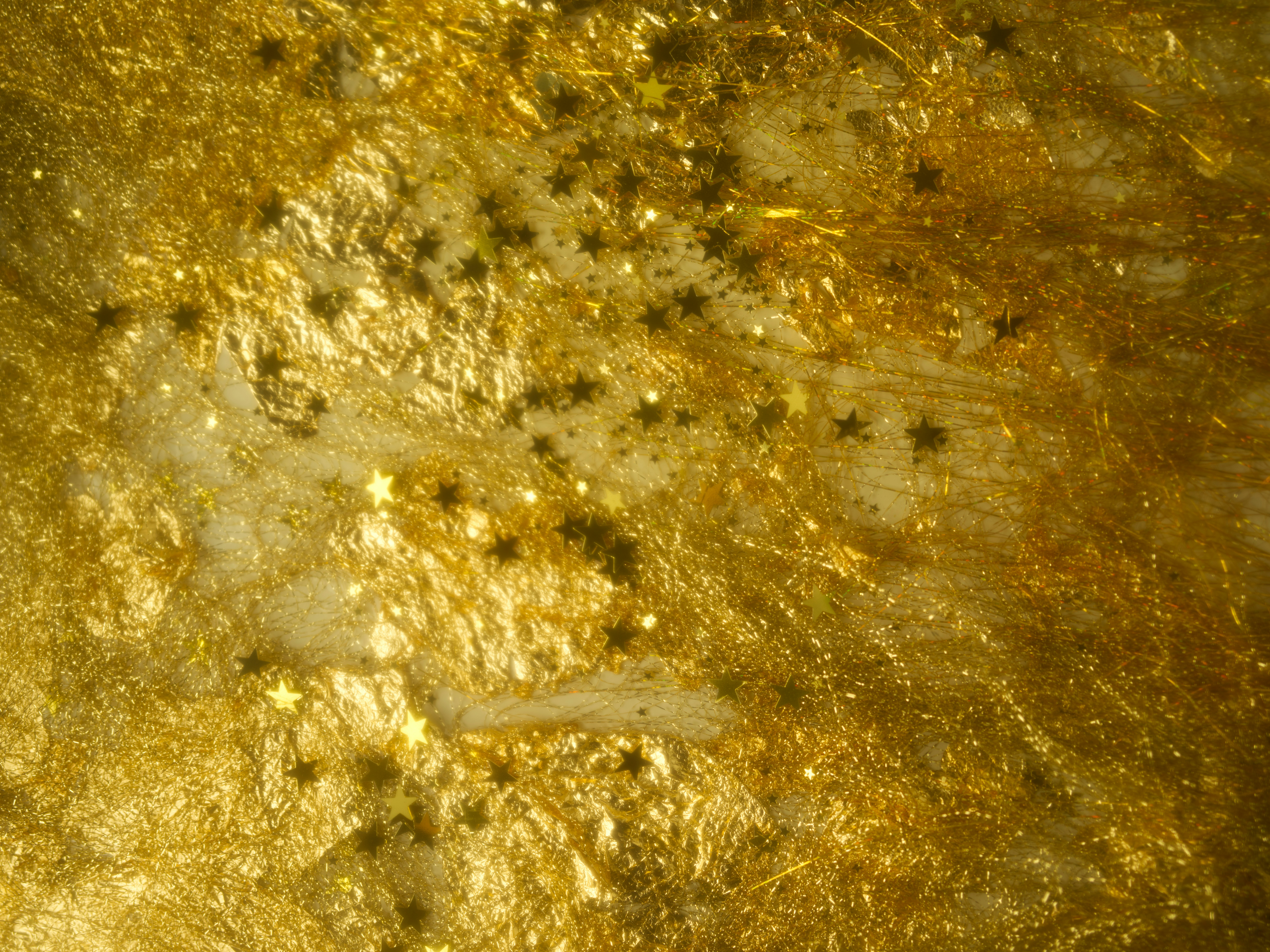 Gold textured background with scattered dark stars
